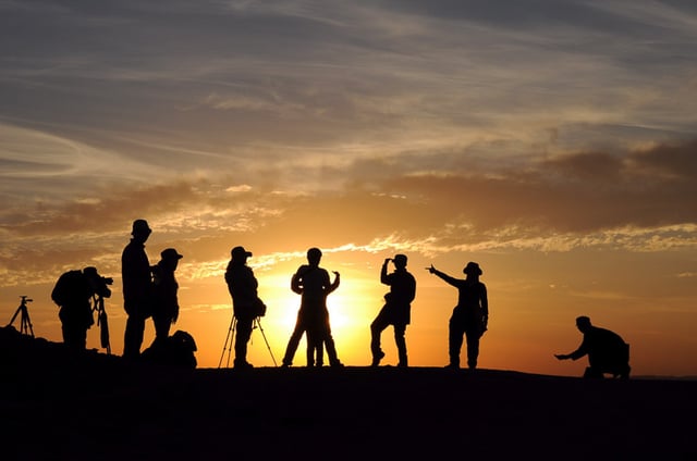 People enjoying a group trip activity at sunset
