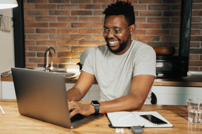 A happy reader checking a welcome email on a computer